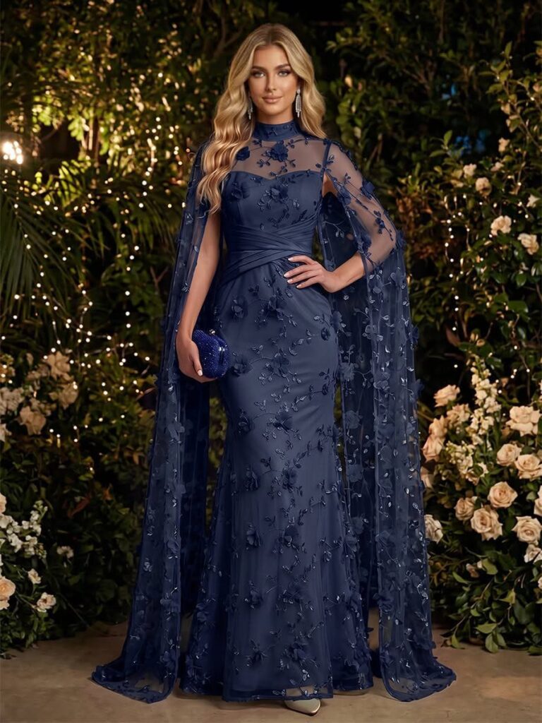 Woman in a navy blue tulle gown with a matching sheer cape and embroidery.