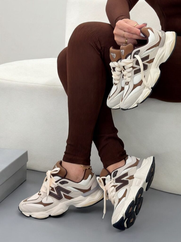 Brown and white chunky sneakers worn with brown ribbed leggings on a white background