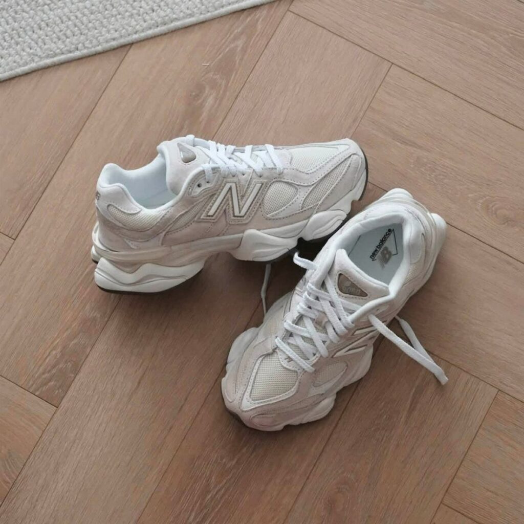 New Balance 9060 sneakers in sea salt and moonbeam on wooden flooring