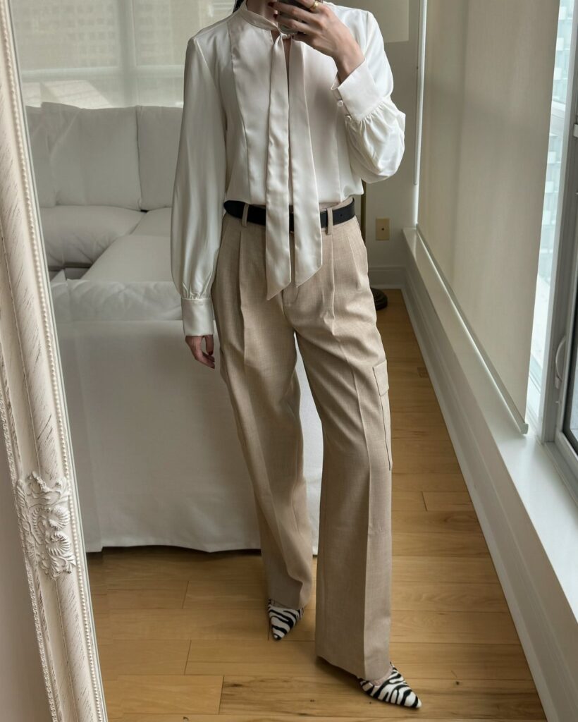 Zebra-print kitten heels worn with tan wide-leg trousers and a white blouse.